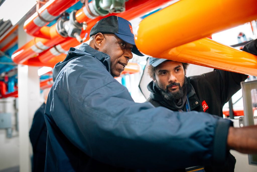 Two CGL employees inspecting equipment.